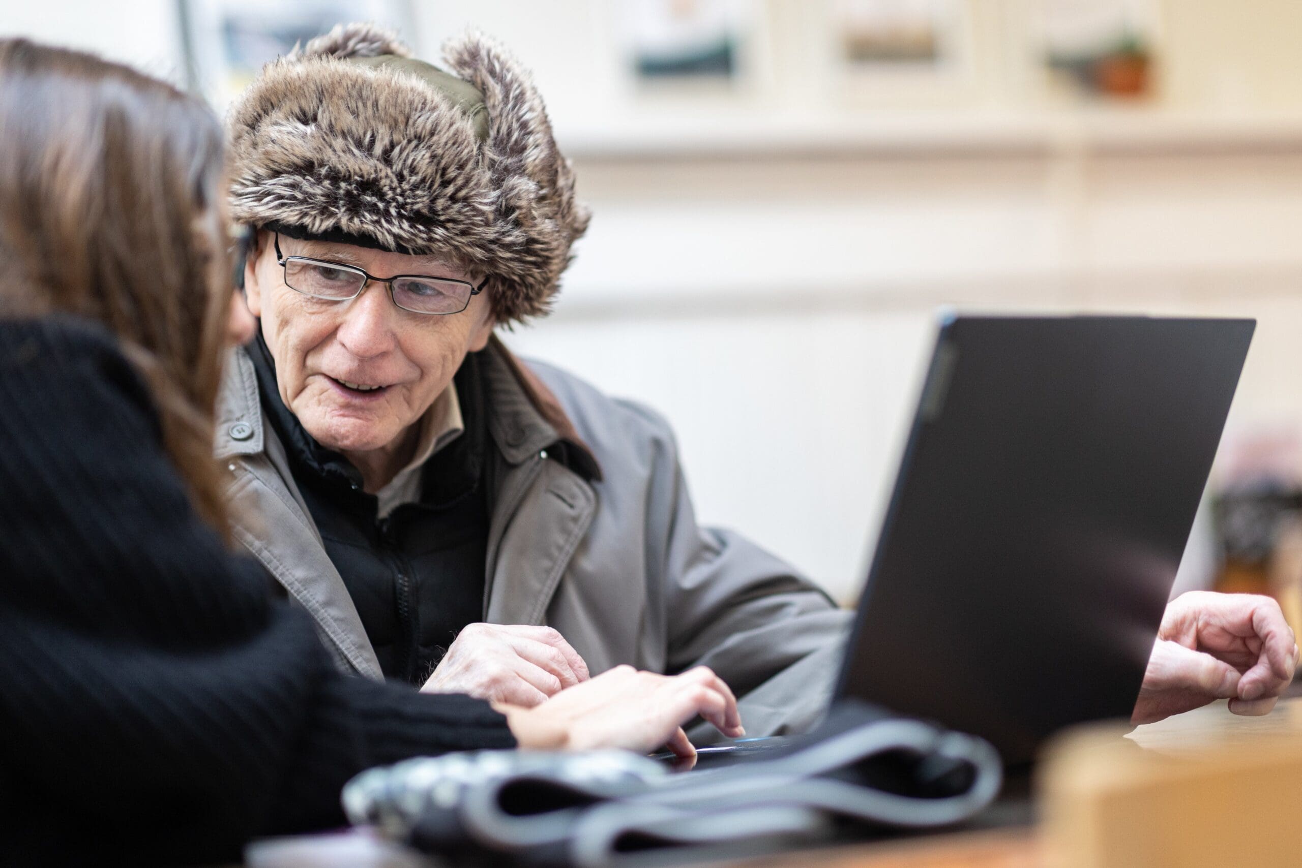 Centre for Better Ageing - Older gentleman with a laptop being given advice.