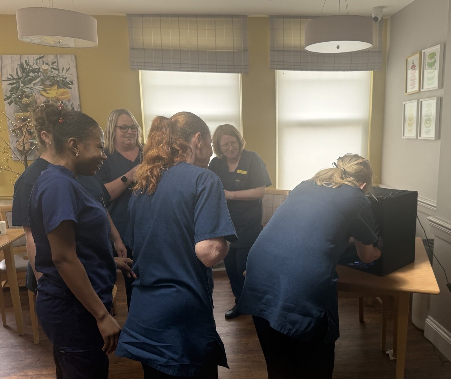 Group of Harbour Rise Care Home staff watching the handwashing kit being used